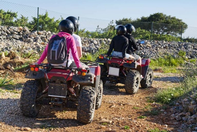 Friends driving off-road with ATV bikes